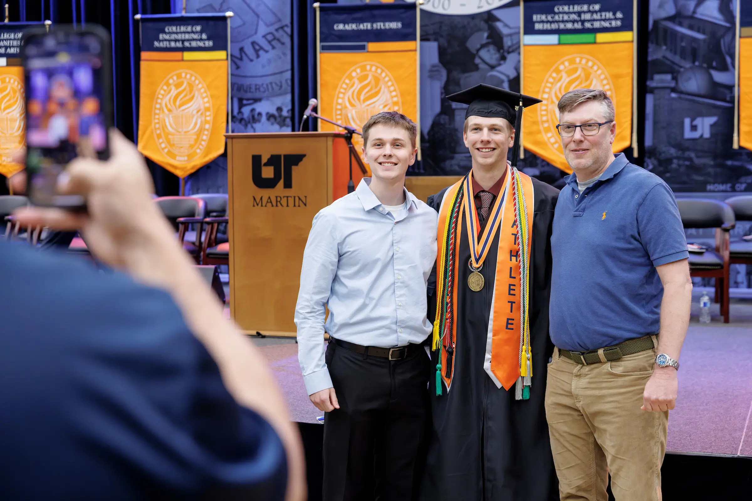 A Skyhawk graduate celebrates with family at commencement.