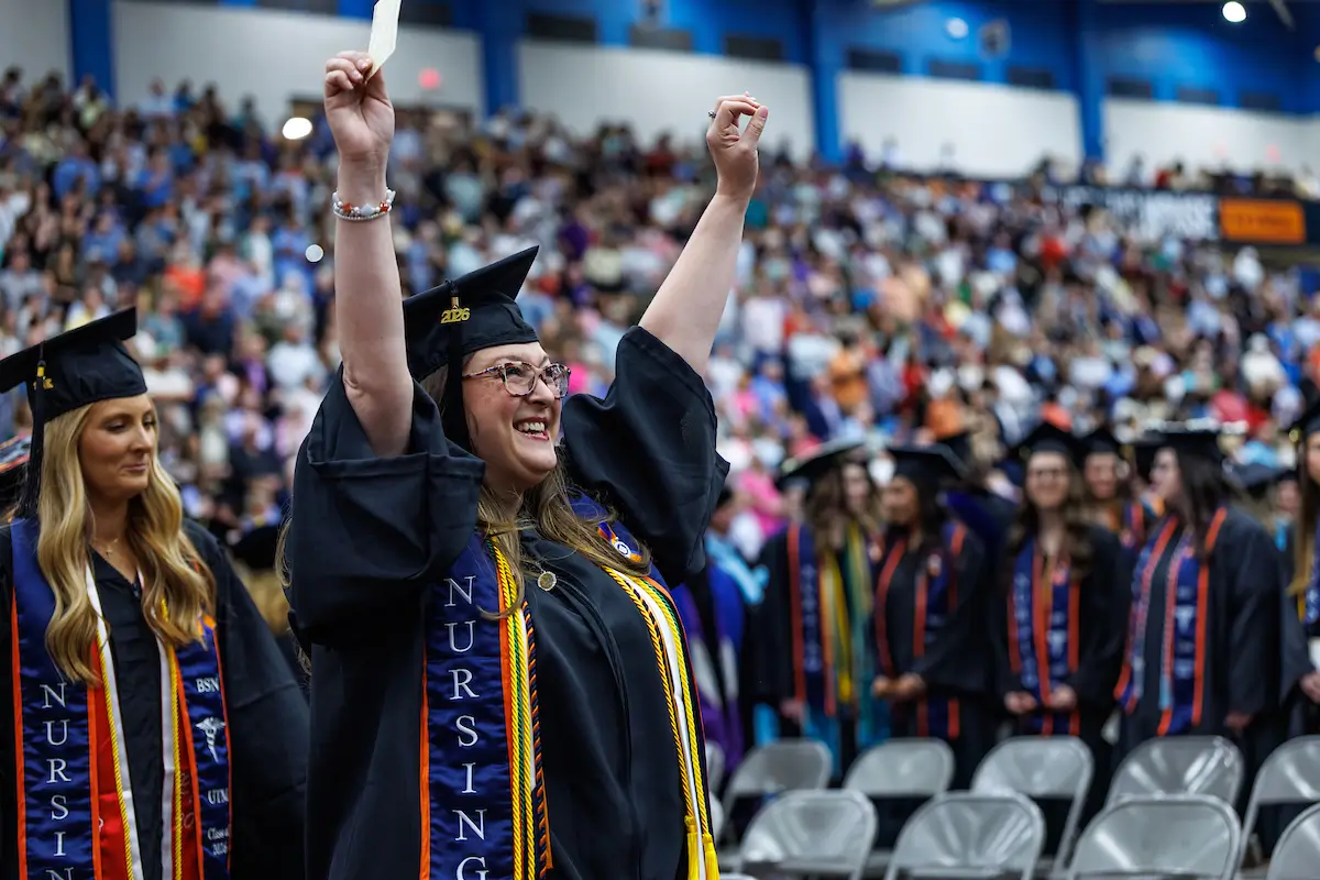 A UT Martin graduate celebrates during commencement.
